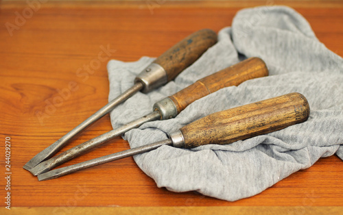 three old screw-drivers on the rag in the workroom photo