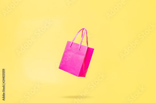 Flying Shop Bag Store Sale Concept Pink and Yellow Color photo