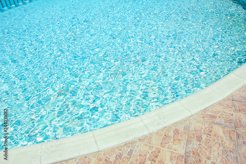 Beautiful swimming pool at the seaside hotel in park background © Kostia