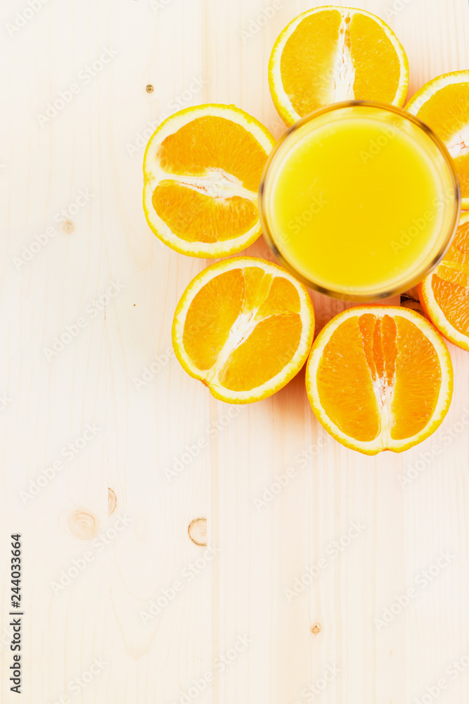 Glass of freshly pressed orange juice with sliced orange halfs Glass of freshly pressed orange juice with sliced orange halfs