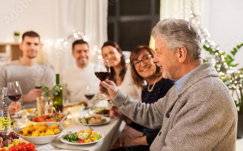 Canvas Print celebration, holidays and people concept - happy family having dinner party, dri