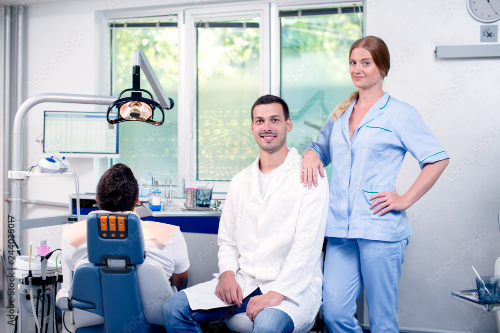 Obraz premium Female dentist check`s her patient teeth at dentist's office.