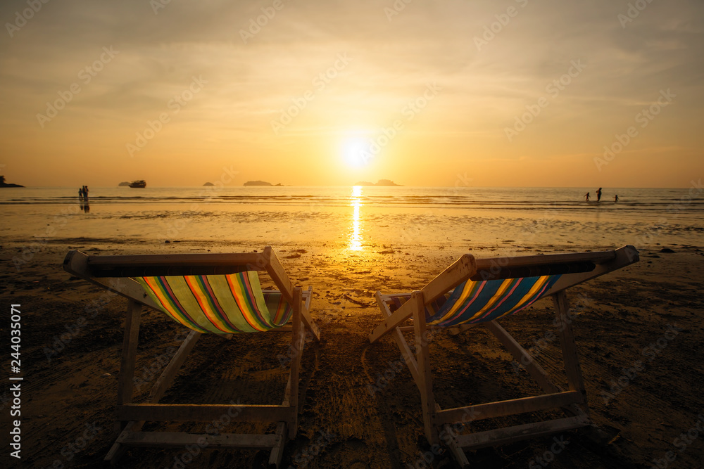 Sun loungers on the sea beach during sunset. Sun loungers on the sea beach during sunset.