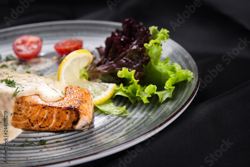 Fish steak salmon grilled with fresh salad