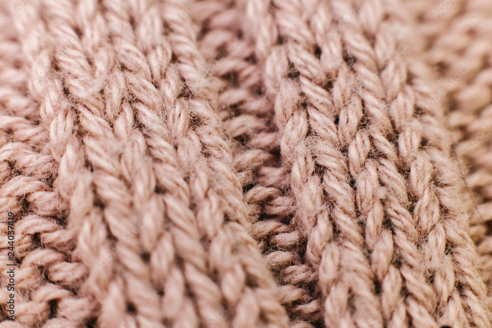 Texture of knitted woolen brown fabric for wallpaper and an abstract background. Soft focus Texture of knitted woolen brown fabric for wallpaper and an abstract background. Soft focus