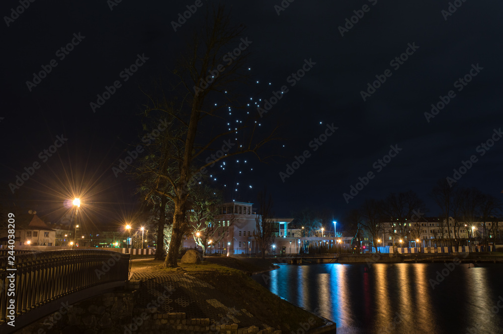 Fototapeta premium Night landscape by the lake with lanterns