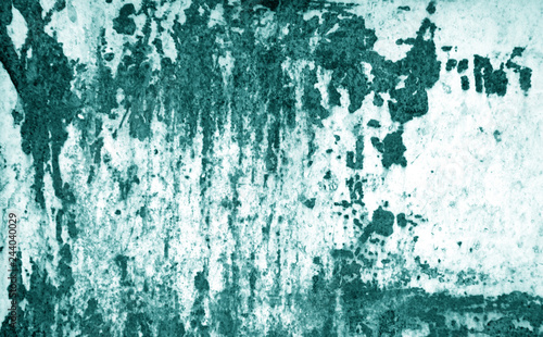 Grungy rusted metal surface in cyan tone.