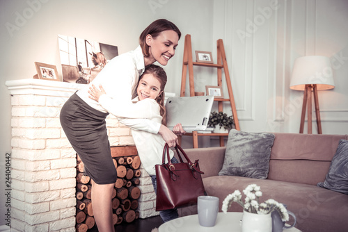 Joyful positive girl meeting her mom from work photo