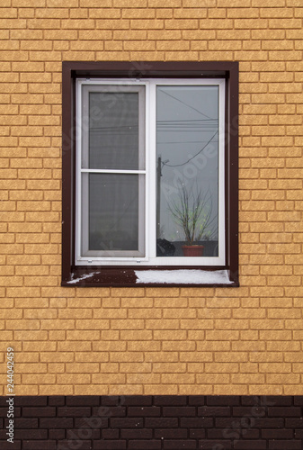 Window in a new brick house as a background