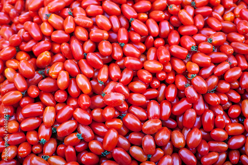 a lot of small tomatoes datterini, background, texture