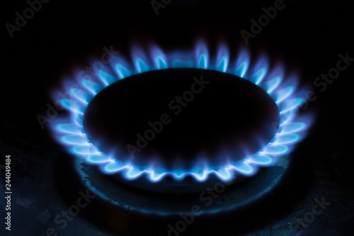 Natural gas burning a blue flames on black background, propane is burning on the gas cooker