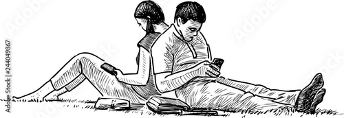 A couple of students resting on the lawn grass