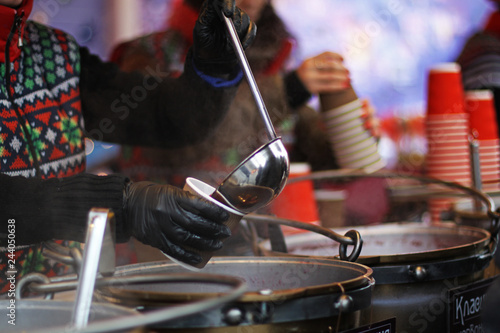 Woman pours a drink in a paper cup