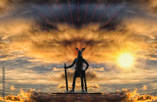 Mythical figure of Old Norse god Odin with sword against backdrop of a dramatic sky with gloomy storm clouds, red lines and bright rising sun, Viking theme, creative illustration photo