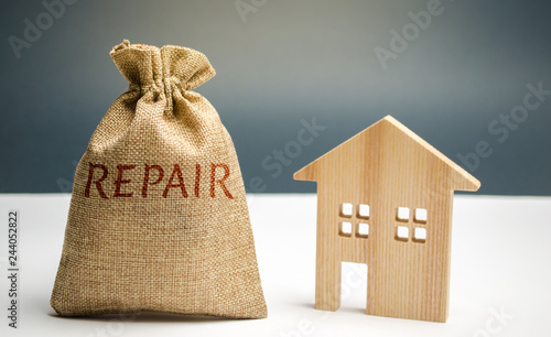 Money bag with the word repair and a wooden house. Saving and accumulation of money to repair. Concept of a new house, apartment or housing. construction industry. property investment. Renovation