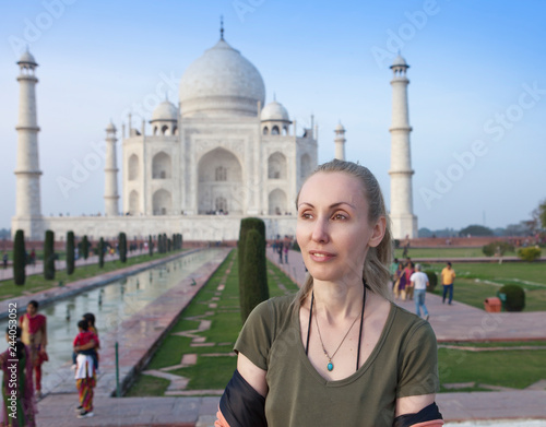 Photography European woman the tourist on the background of Taj Mahal..