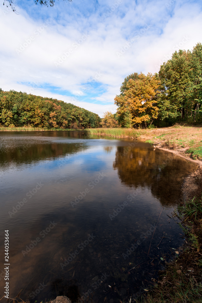 autumn. lake with a mirror surface and yellow trees on the shore. autumn. lake with a mirror surface and yellow trees on the shore.