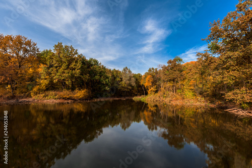 autumn. lake with a mirror surface and yellow trees on the shore.