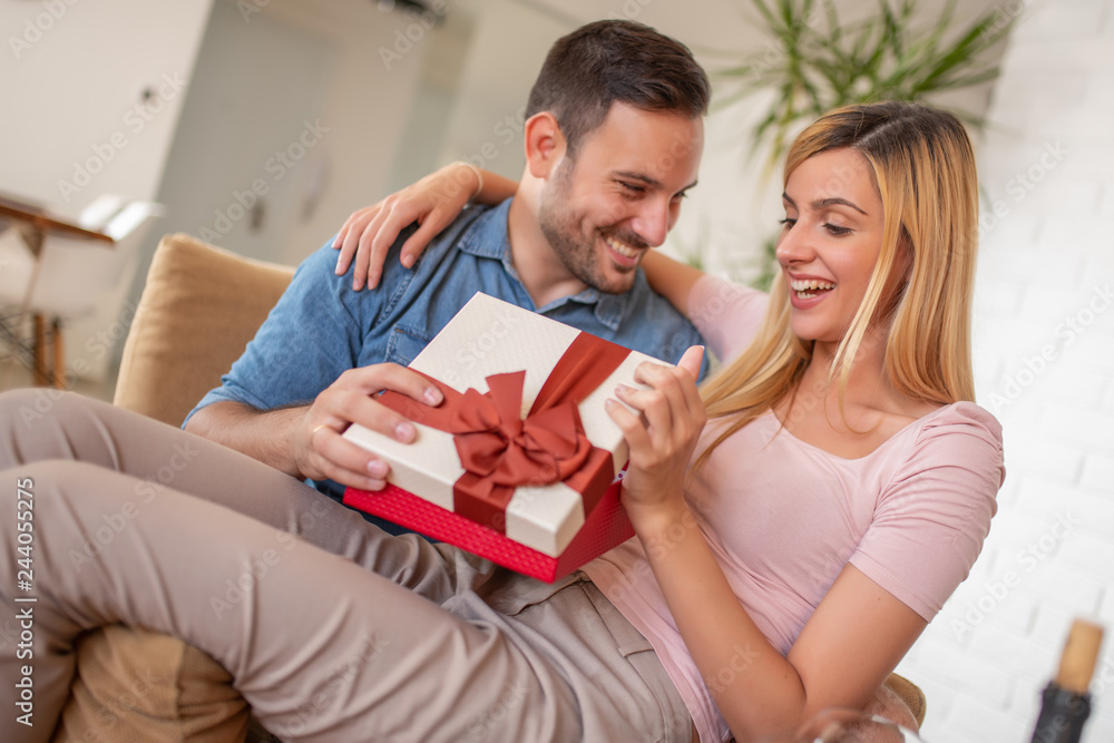 Beautiful young couple celebrating at home Beautiful young couple celebrating at home