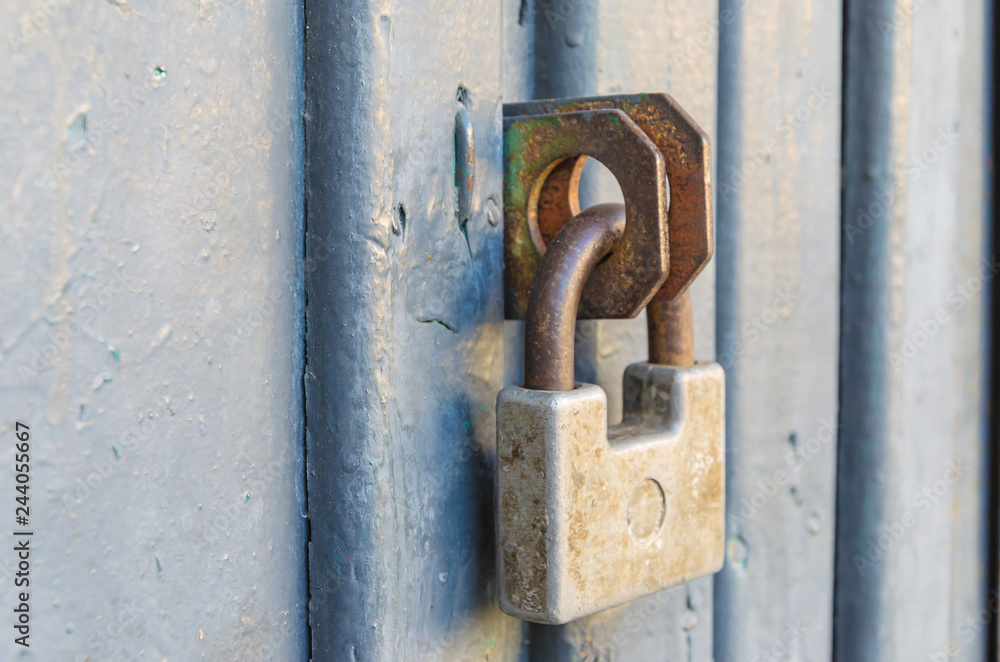 Closed front door with an old padlock. Closed front door with an old padlock.