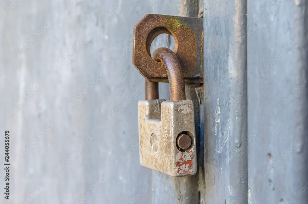 Closed front door with an old padlock. Closed front door with an old padlock.