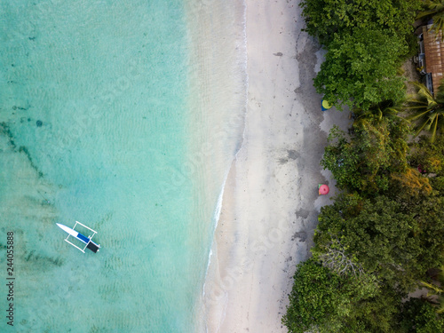 Indonesia, Sumbawa, West Sumbawa, Aerial view of banca boat and Jelengah beach photo