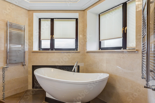 Stylish bathroom with rounded ceramic bath.