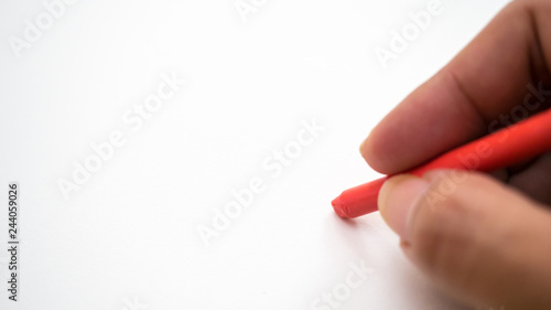 crayon with man hand on white background