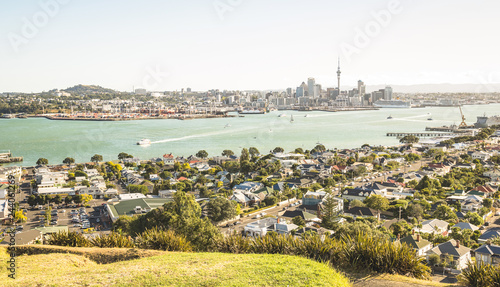 Breathtaking view of Auckland city skyline and bay gulf from Mount Victoria in Devonport area - High angle sight of the New Zealand world famous town - Bright greenish vintage filter photo