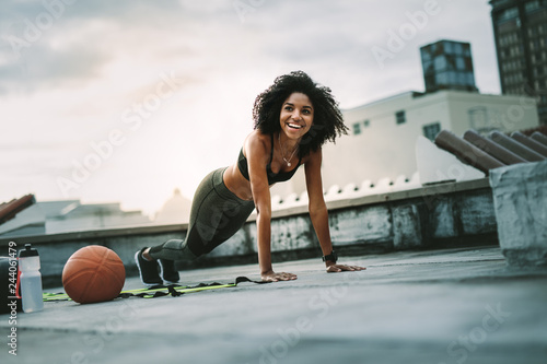 Fitness woman doing push ups on rooftop © Jacob Lund