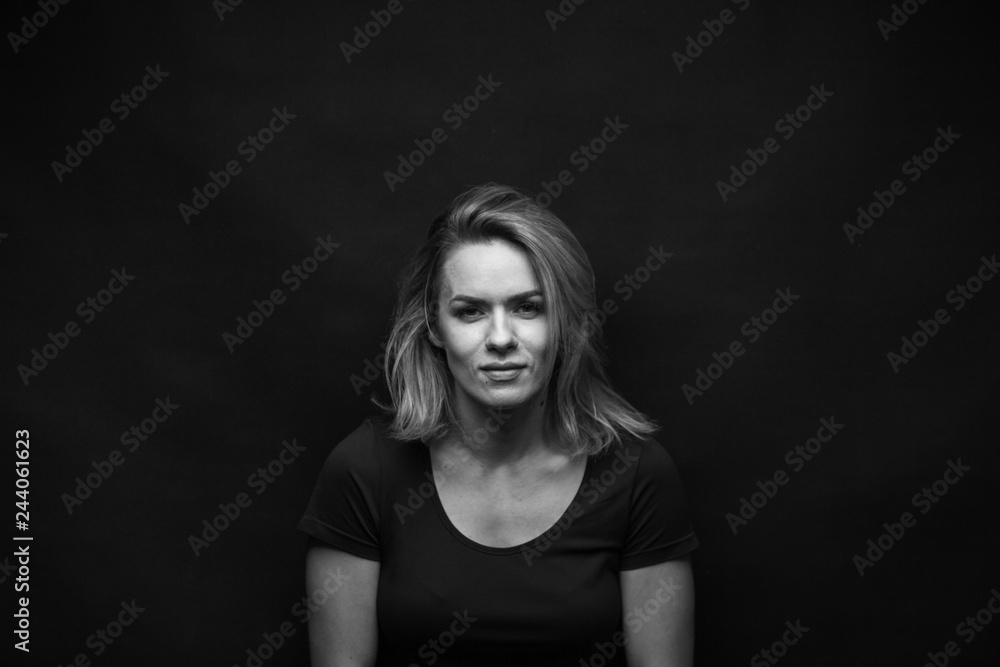 Dramatic black and white portrait of a beautiful woman on a dark background Dramatic black and white portrait of a beautiful woman on a dark background