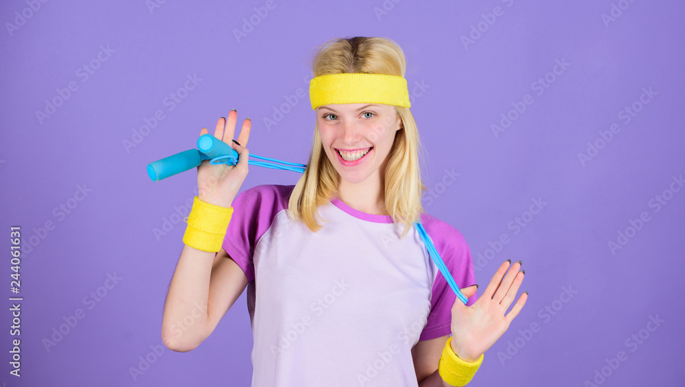 Girl hold jumping rope wear bright wristbands. Woman exercising with jumping rope. Jumping exercise benefits. Proper approach to lose weight. Weight loss concept. Jumping rope is great calorie burner Girl hold jumping rope wear bright wristbands. Woman exercising with jumping rope. Jumping exercise benefits. Proper approach to lose weight. Weight loss concept. Jumping rope is great calorie burner