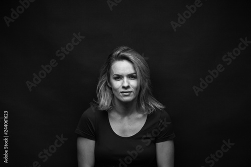 Dramatic black and white portrait of a beautiful woman on a dark background © Restyler