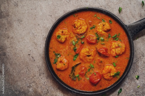 Homemade shrimp curry / Curried prawns in a skillet overhead view