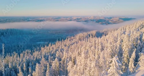 Aerial winter nature nordic landscape snowy mountain forest and lake on sunset