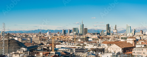 Milan skyline. Large panoramic view of Milano city  Italy. The mountain range of the Lombardy Alps in the background. Italian landscape.