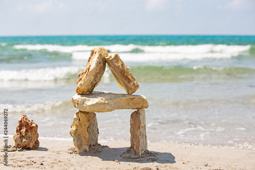 House made of stones against the sea, background sea. Sea stones on the background of the sea House made of stones against the sea, background sea. Sea stones on the background of the sea
