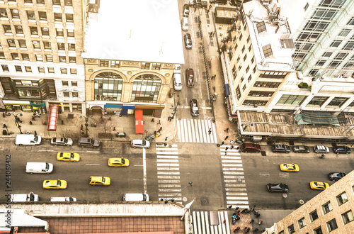 Aerial view of New York street and classic building in Manhattan financial district - High angle from skyscraper in urban business downtown area - United states world famous city - Warm vintage filter