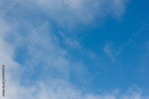 Morning sunrise. Blue sky with clouds. The morning sun illuminates the clouds.