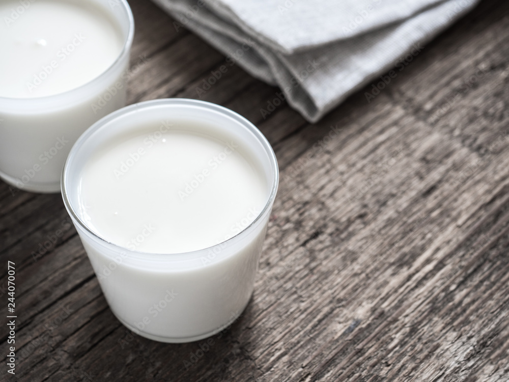 Healthy breakfast. Yogurt in white glasses on wooden background. Copy space Healthy breakfast. Yogurt in white glasses on wooden background. Copy space