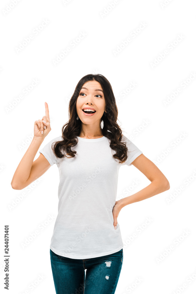 smiling young woman pointing up with finger and looking away isolated on white smiling young woman pointing up with finger and looking away isolated on white