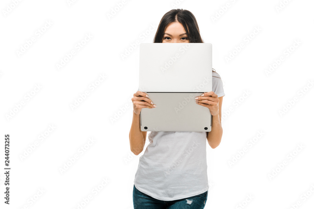 young brunette woman holding laptop and looking at camera isolated on white young brunette woman holding laptop and looking at camera isolated on white