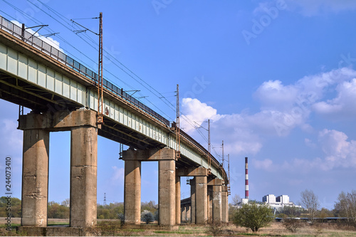 A flyover with a railway line and a chimney of a heat and power plant near Poznań.