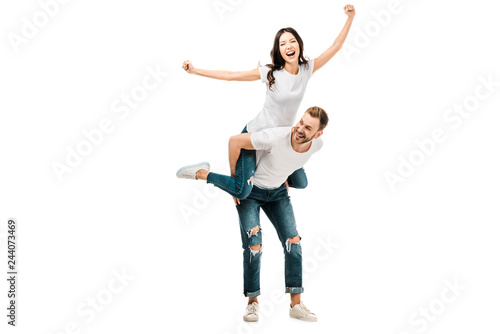 cheerful young couple piggybacking and having fun together isolated on white