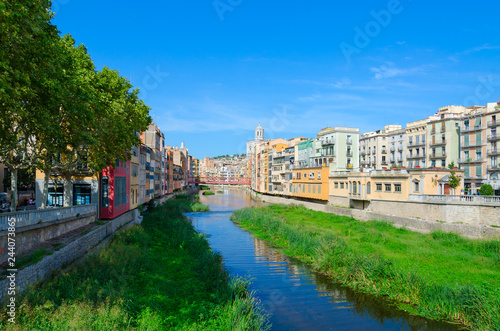 View of Eiffel Bridge over River Onyar, Cathedral and buildings of city of Girona, Spain