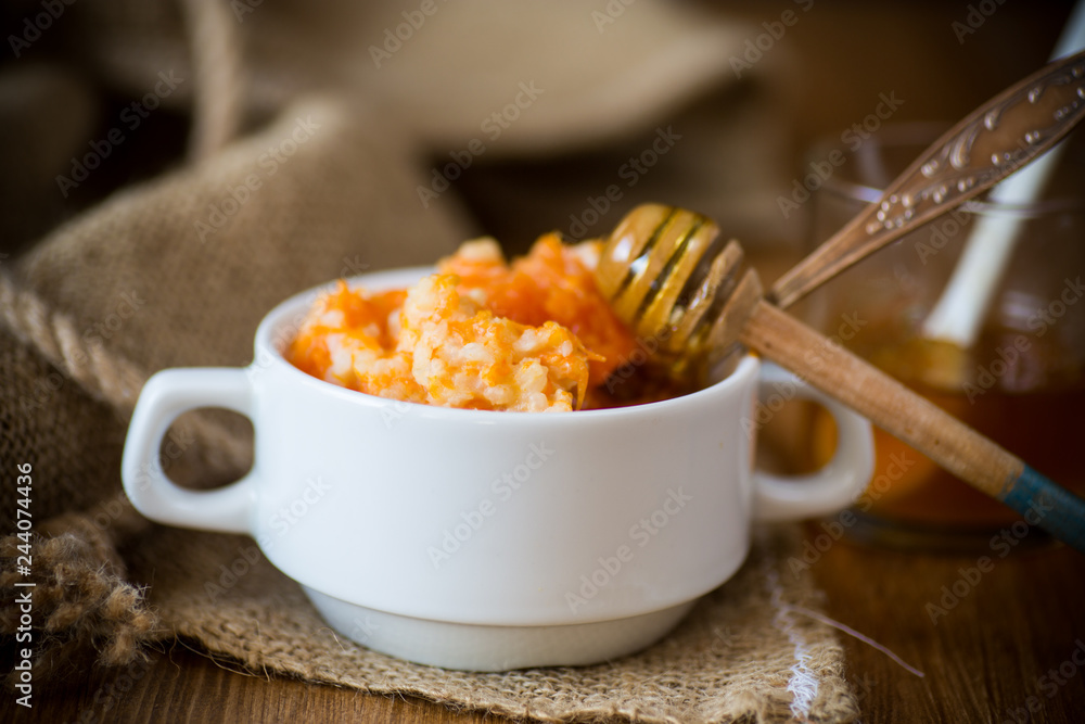 sweet boiled pumpkin porridge with rice in a plate on a wooden sweet boiled pumpkin porridge with rice in a plate on a wooden