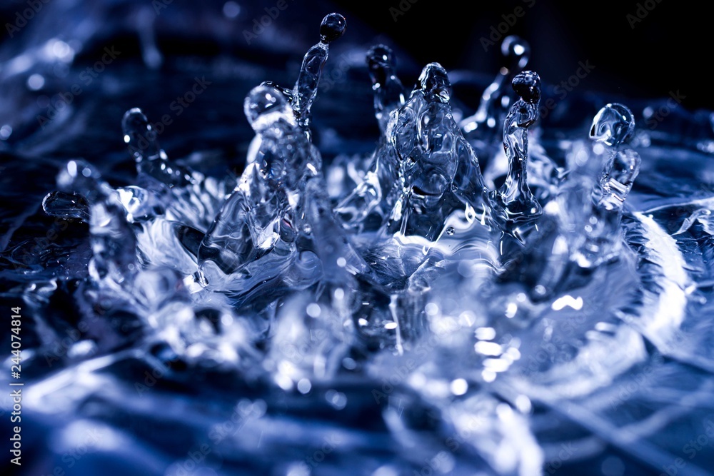 Water drops splashing on acoustic membrane. A lot of drops in air. High frequency of sound waves. Water cloud small drops. Frozen time shot. Water drops splashing on acoustic membrane. A lot of drops in air. High frequency of sound waves. Water cloud small drops. Frozen time shot.