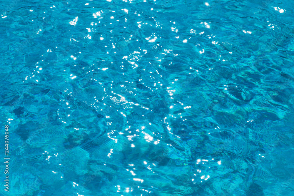 Blue pool water with sun reflections Blue pool water with sun reflections
