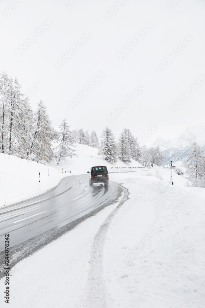 Van driving along snowcapped mountain road Van driving along snowcapped mountain road