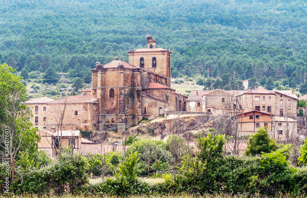 Vinuesa with its Romanesque church on a sunny day. It is a town in the province of Soria in Spain.